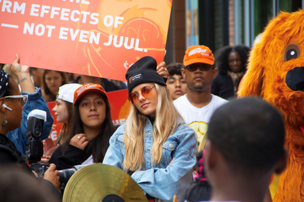 a group of 3 people in a crowd looking at the camera