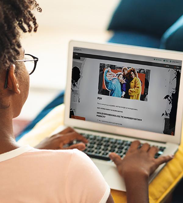 Over-the-shoulder view of a young person with glasses using a laptop, viewing a truth campaign webpage with the heading "POV."